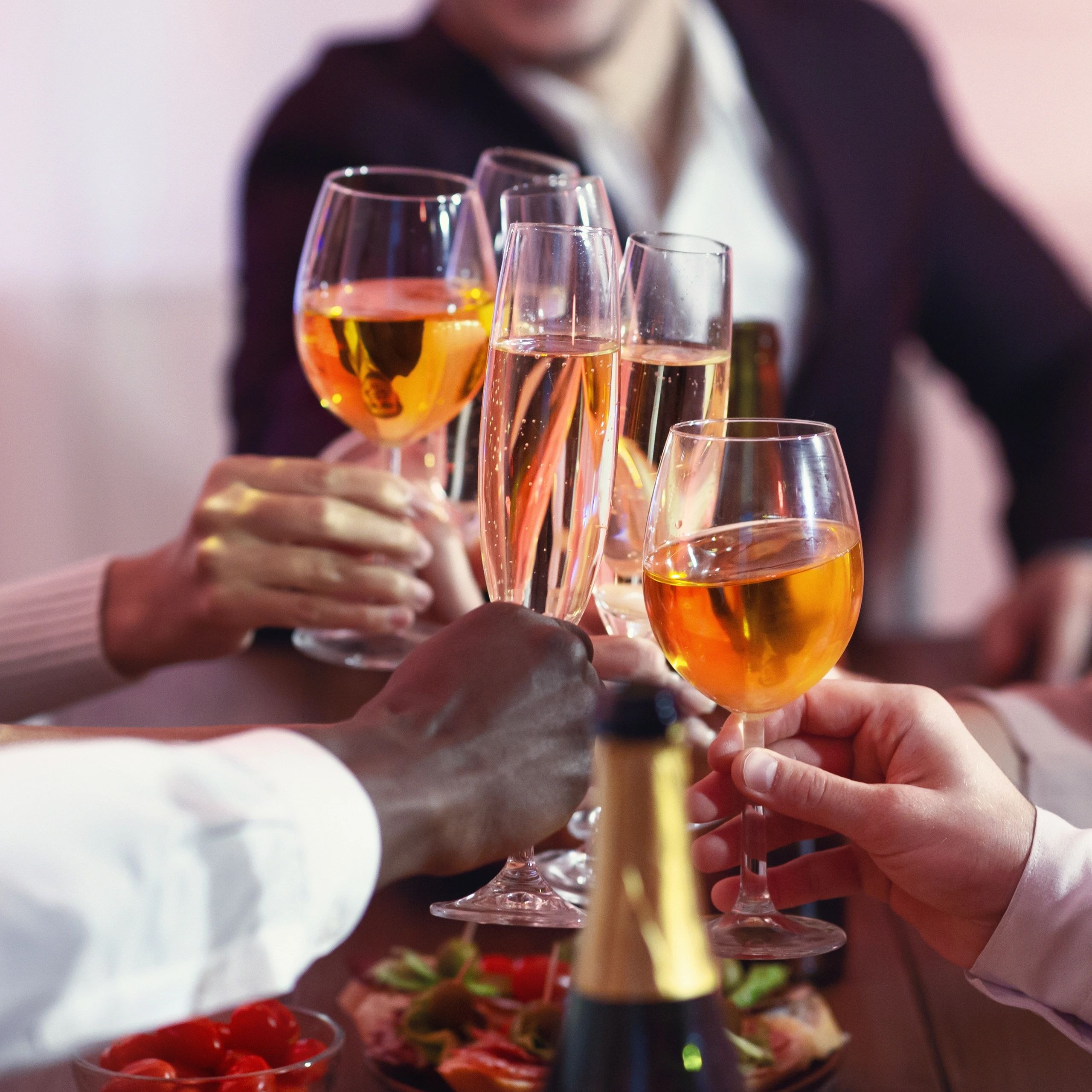 Guests toasting wine glasses in celebration at a Vegas 2 U event